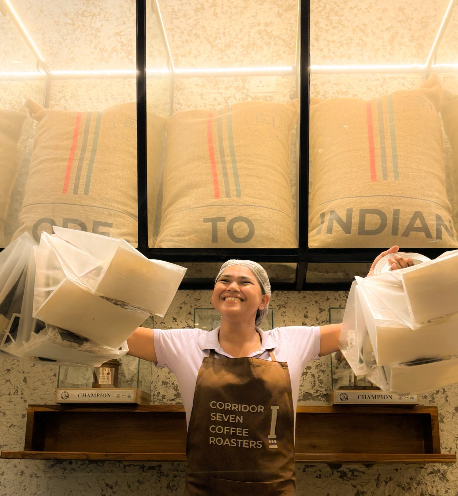 A smiling Brim team member carrying takeaway boxes